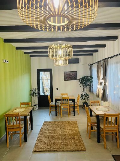 Shared dining room at Somni accommodation in Chinteni, suitable for small events.